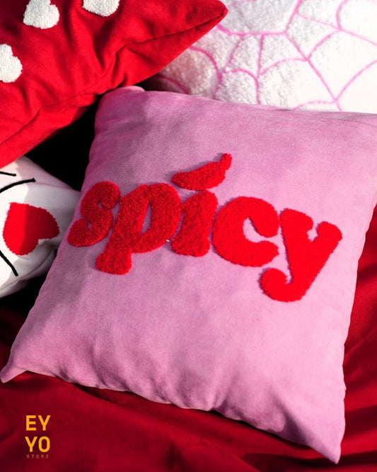 Pink pillow with red 'spicy' text on a red background, Spicy energy text tufted cotton cushion cover on pink fabric