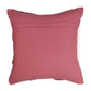 Pink pillow with frayed edges on a white background