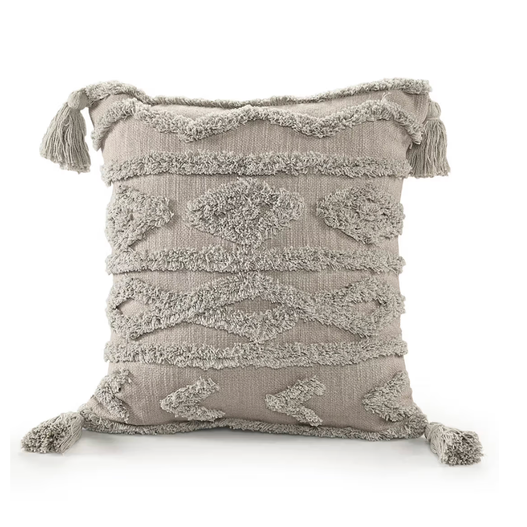 Textured pillow with tassels on a white background